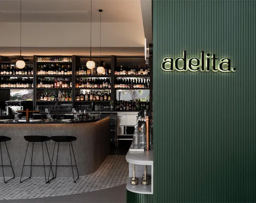 looking into a wine bar with an emeral green wall