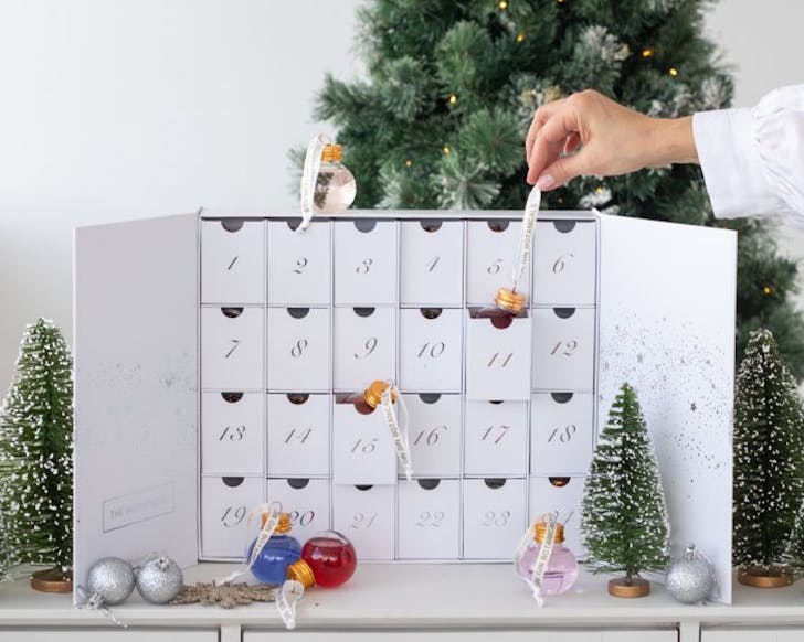 Someone plucks a bell out of 3D advent calendar.