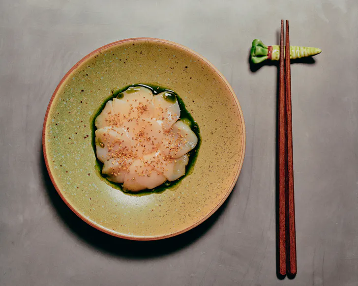 Whitefish sashimi dressed on a plate at Aenza in Darlinghurst.
