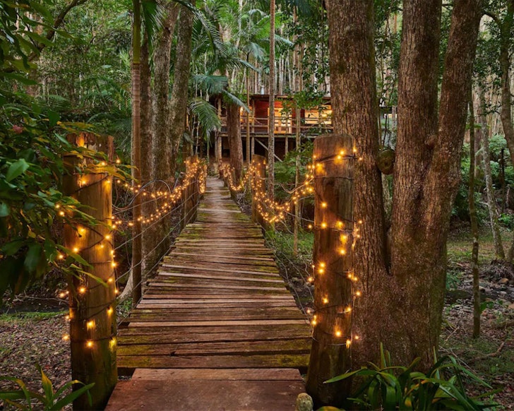 Fairy lights over the bridge at Magical Rainforest Retreat one of the best NSW Airbnbs