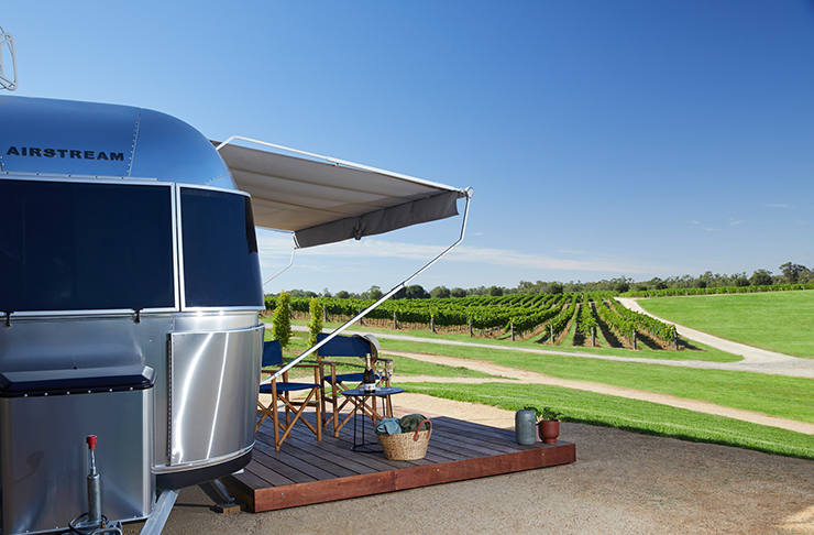 An airstream overlooking a winery.