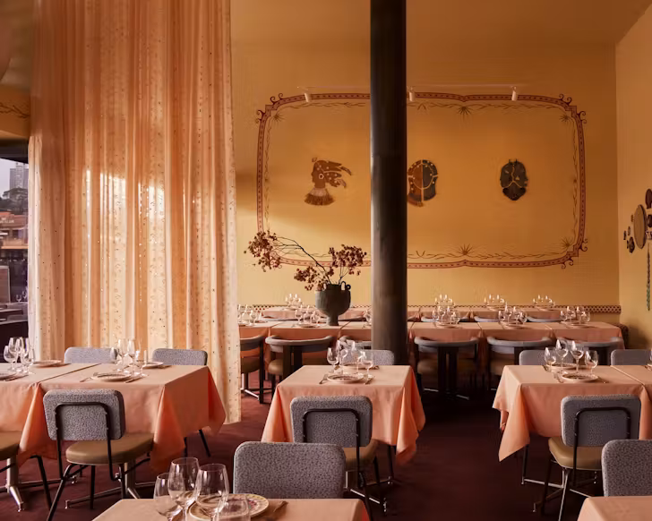 the pink and orange-coloured dining room at woolloomooloo greek restaurant akti