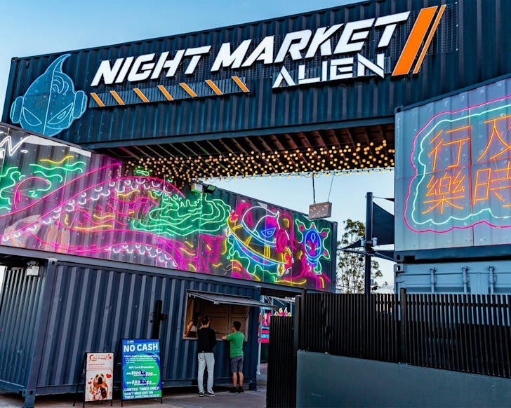 shipping containers marking the front entrance of alien night market brisbane