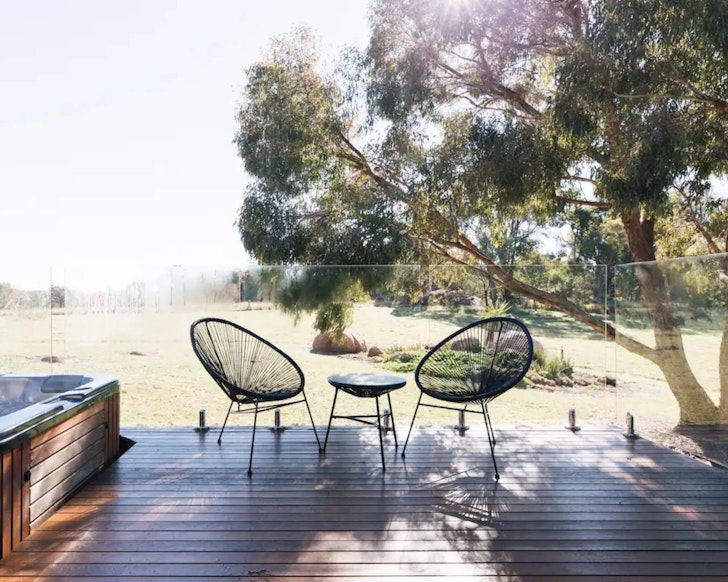 Seats on the deck with a countryside view at Alure one of the best romantic getaways Queensland