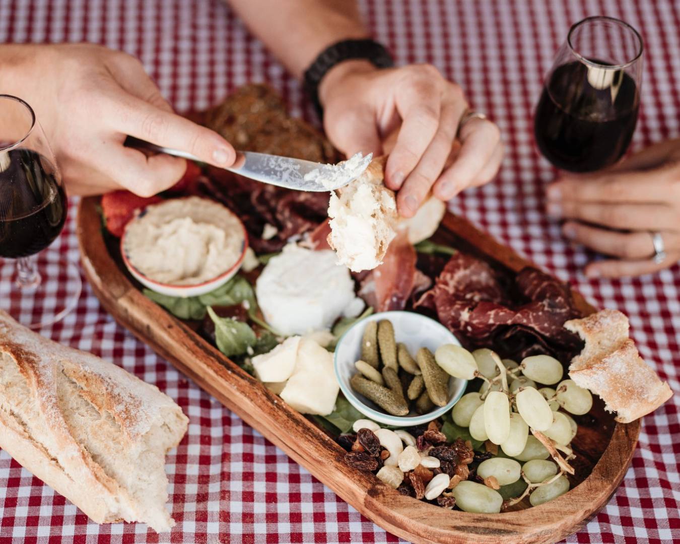 picnic platter with hands reaching for cheese