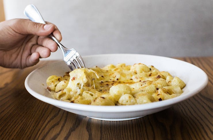 A fork digs into the mac n cheese from Andiamo
