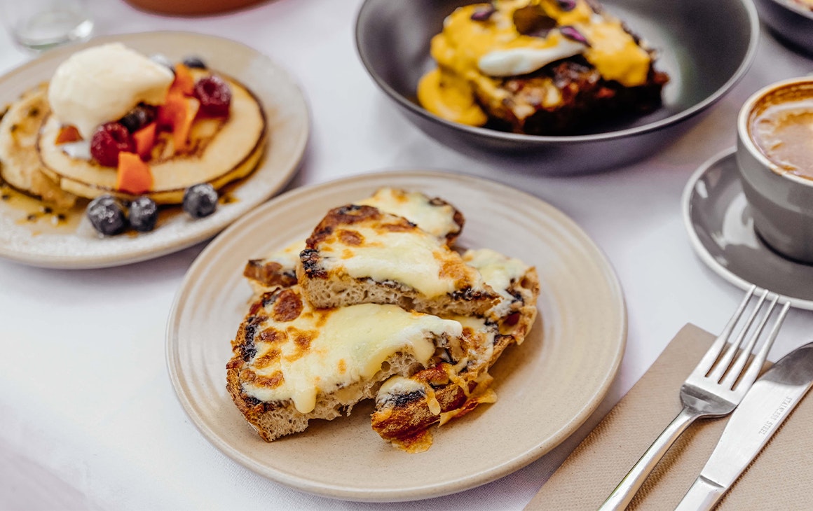 a cheesy toast dish at ant and ola