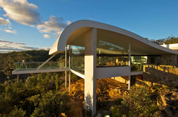 An architectural home built into a cliff face.