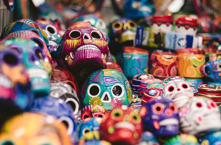A pile of beautifully decorated ceramic Day Of The Dead skulls.