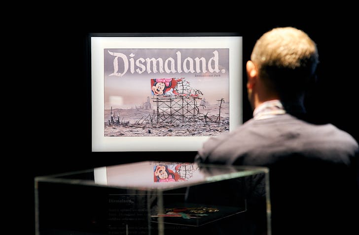Someone gazes at an installation of one of Banksy's 'Dismaland' artworks.