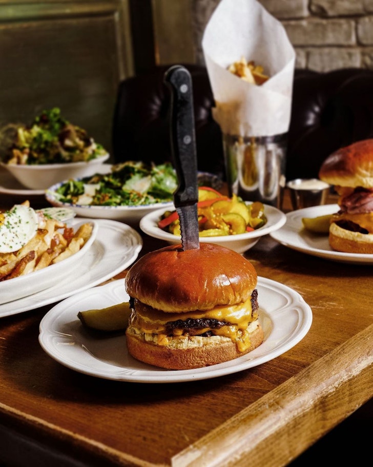 plate with burger and knife and sides
