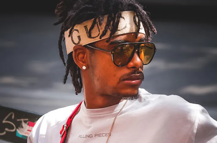 A man wearing a Gucci headband. 