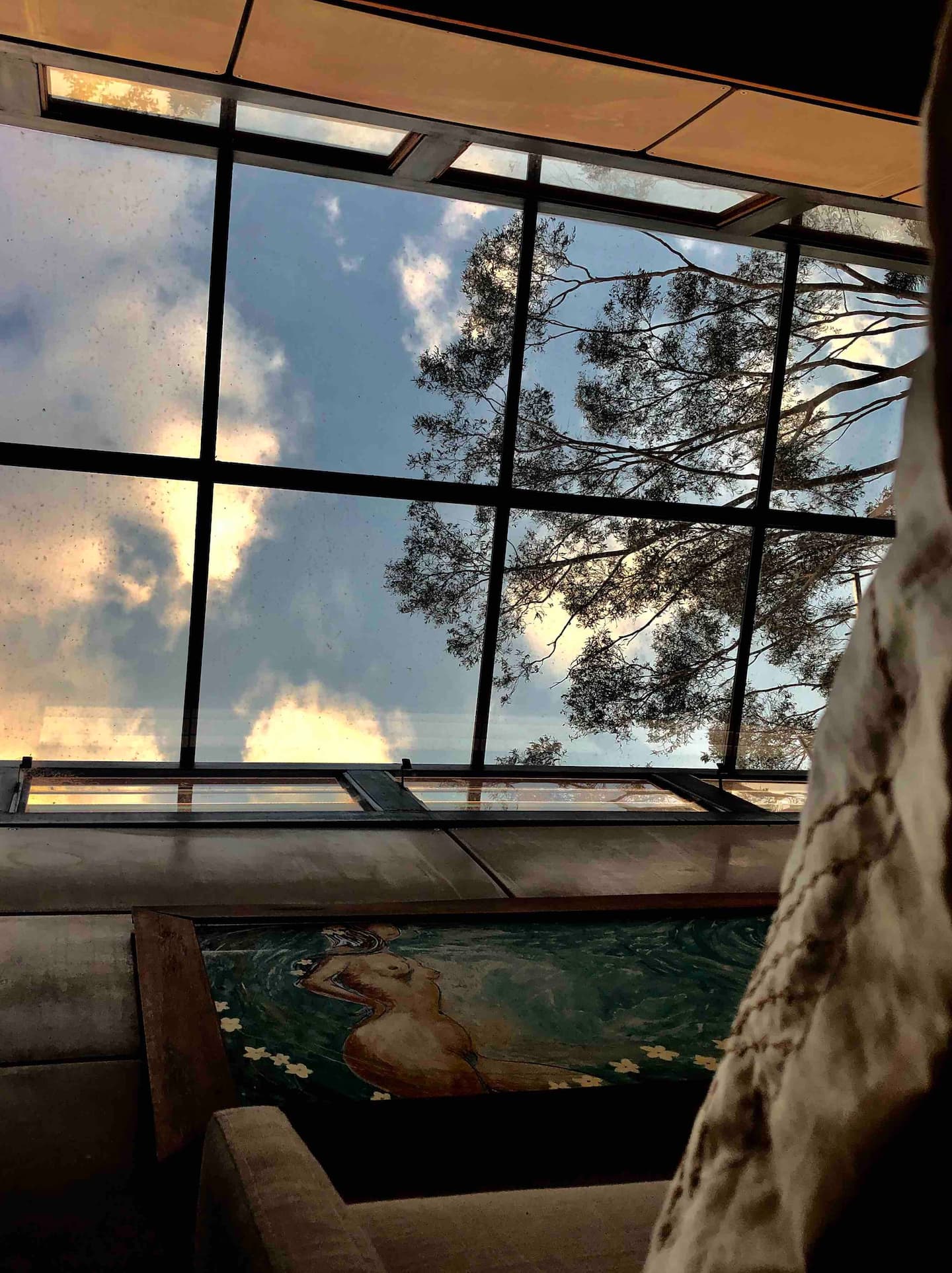 view above a bed to a glass roof