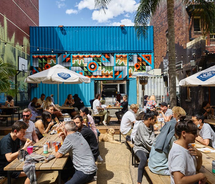 A Sunny Beer Garden With Patrons