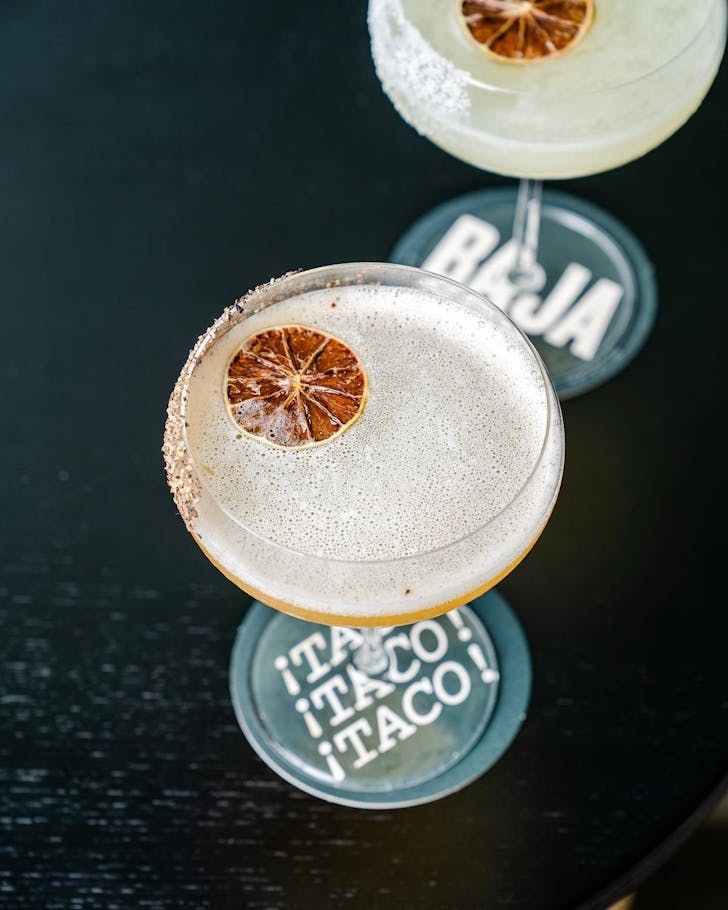 two cocktails sitting on a table