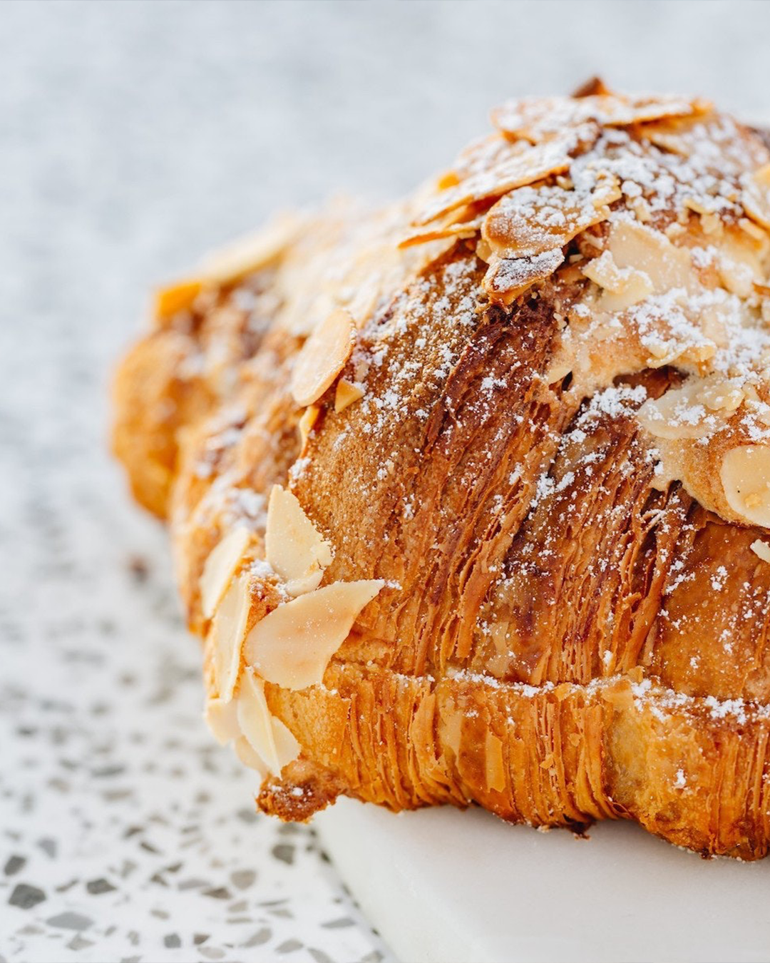 a close-up of a flakey almond croissant