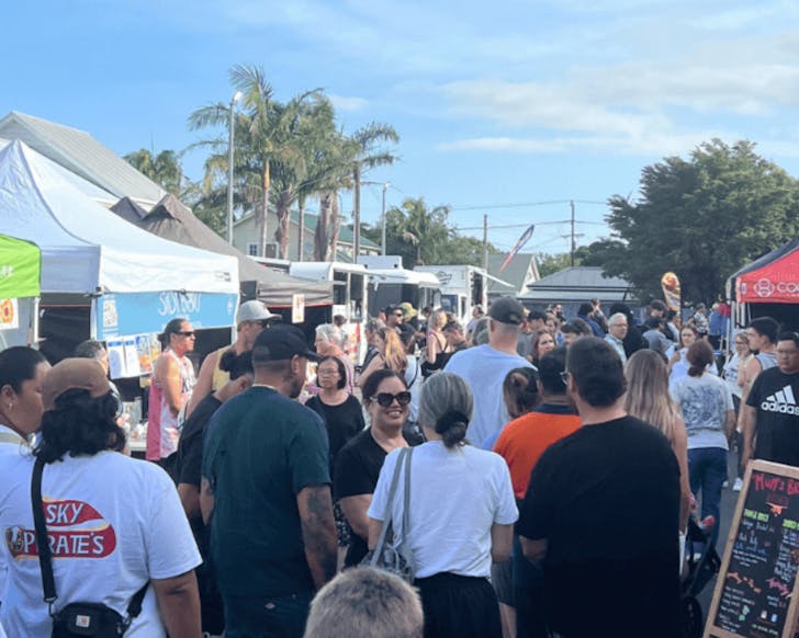 People crowding between the stalls at Balmoral Street Food Market on a sunny day.