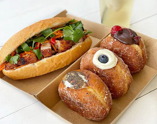 a banh mi and doughnuts in a box
