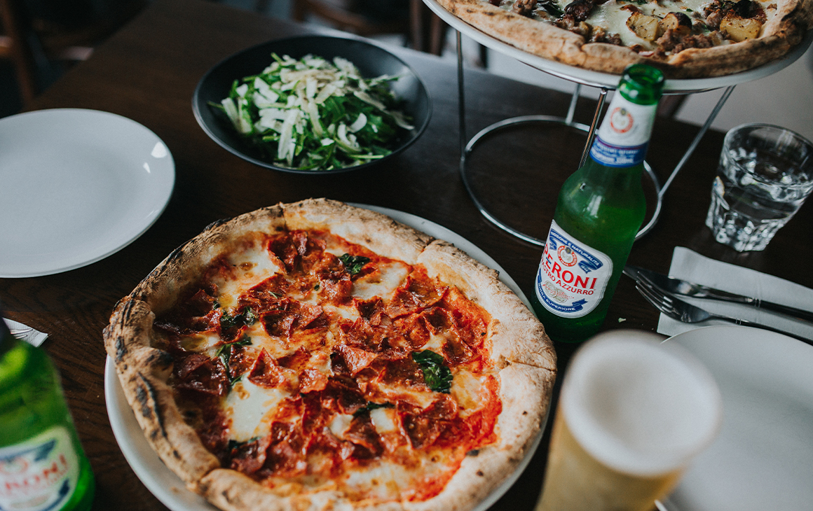 pizzas and beer on a table