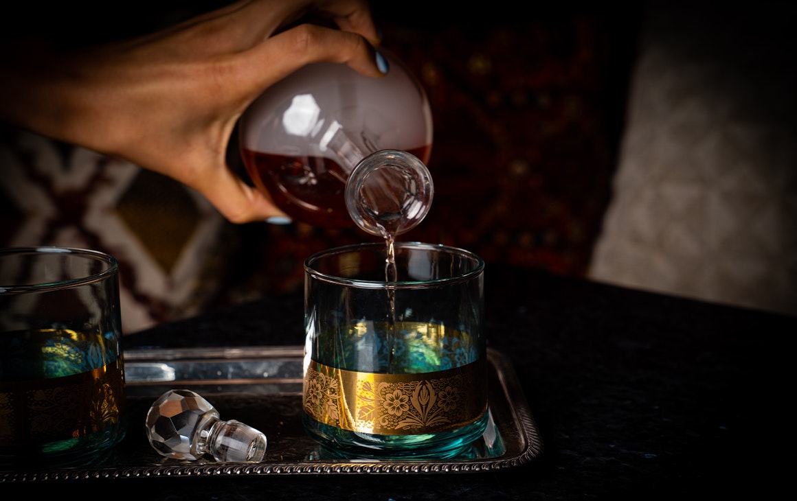 cocktail in a smoke filled glass bottle