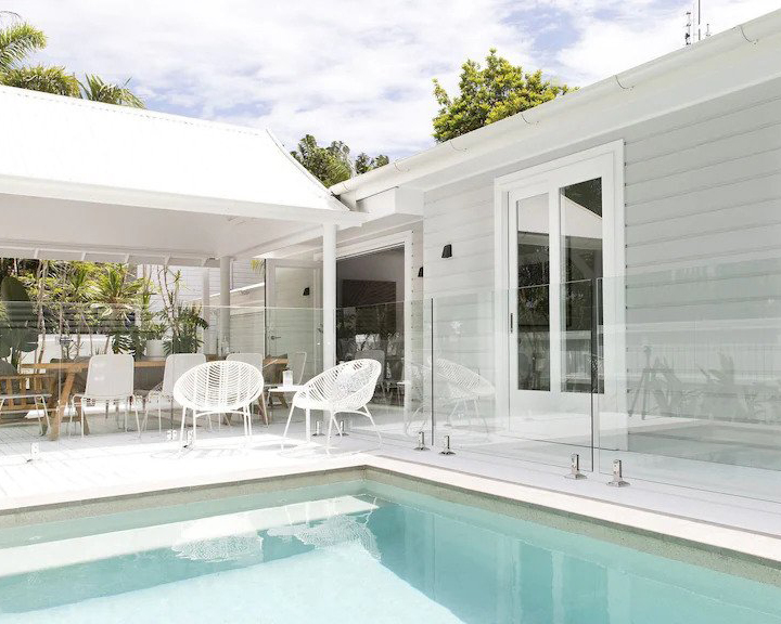 a white Byron Bay airbnb with large pool