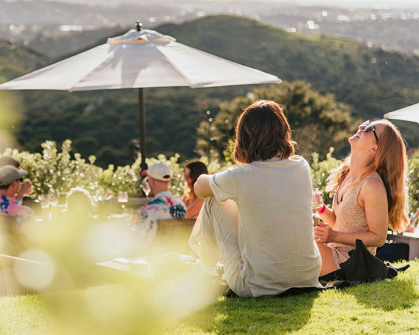 People sit on the grass outside Batch Winery.