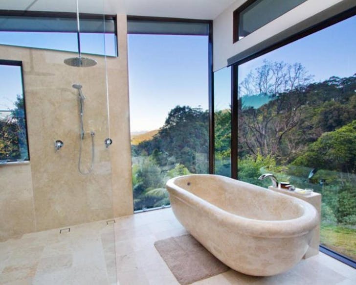 bathtub overlooking beautiful view of green valley