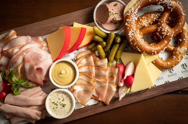 A Bavarian Bottomless Meat And Cheese Platter with pretzels. 