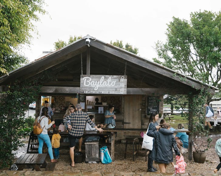 A wooden shack housing Baylato, The Farm's on-site dairy and milk-bar