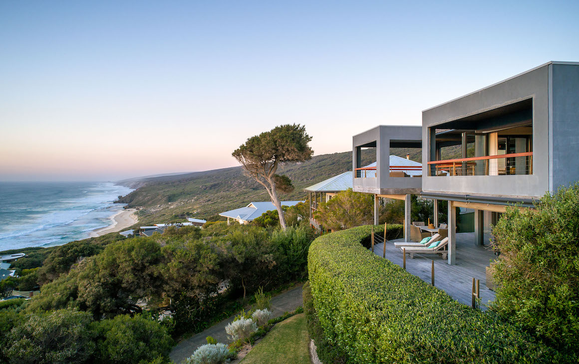 a beach house on a cliff overlooking the ocean