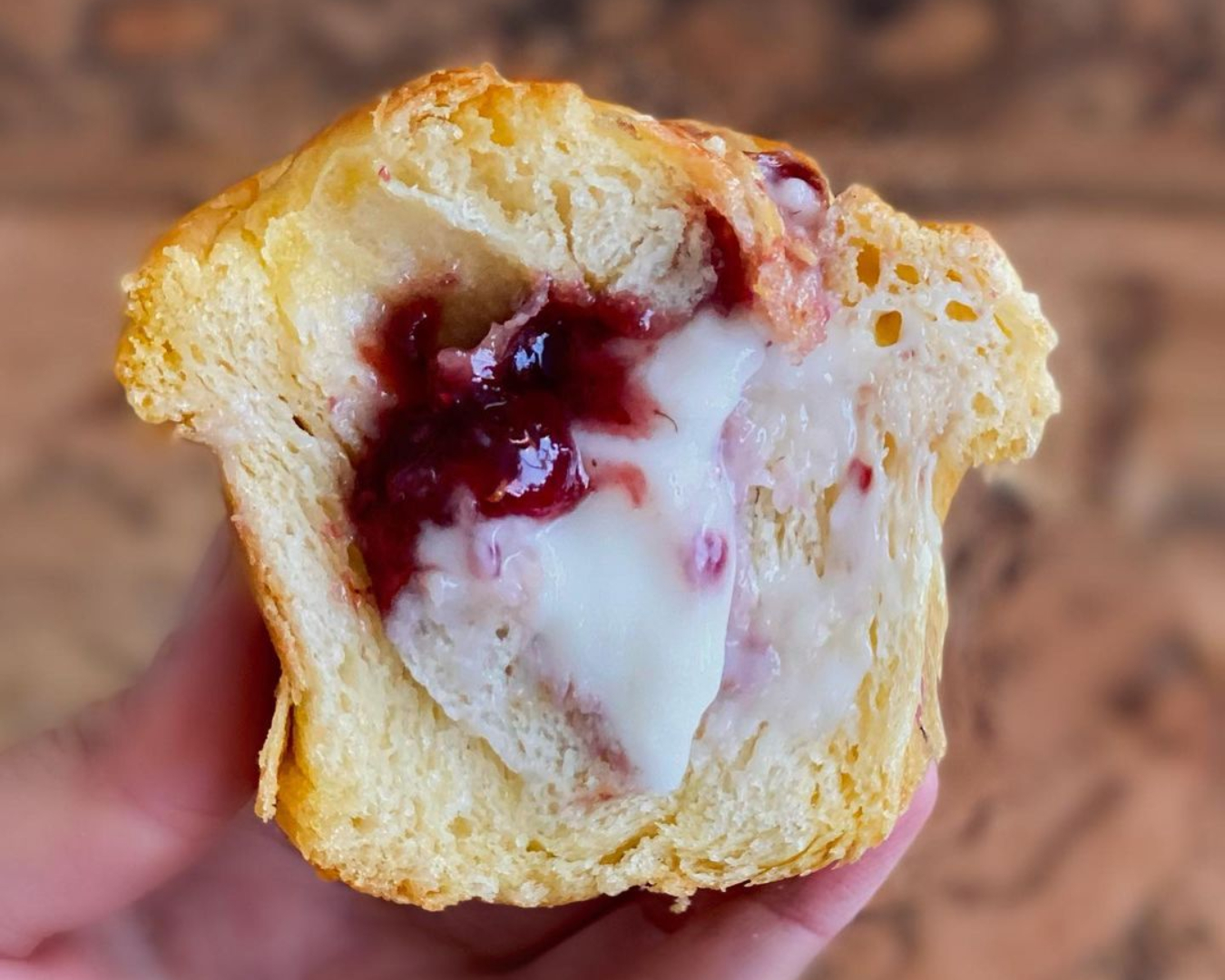 An inside shot of the vanilla custard and raspberry jam cruffin from Belén Bakery