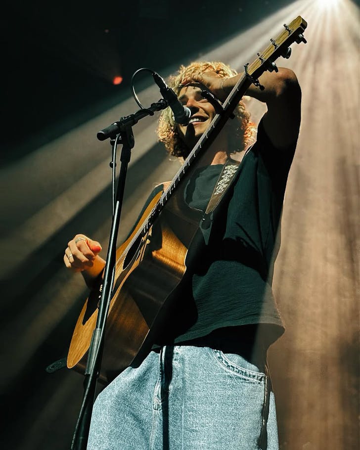 Ben Morgan on stage with his guitar
