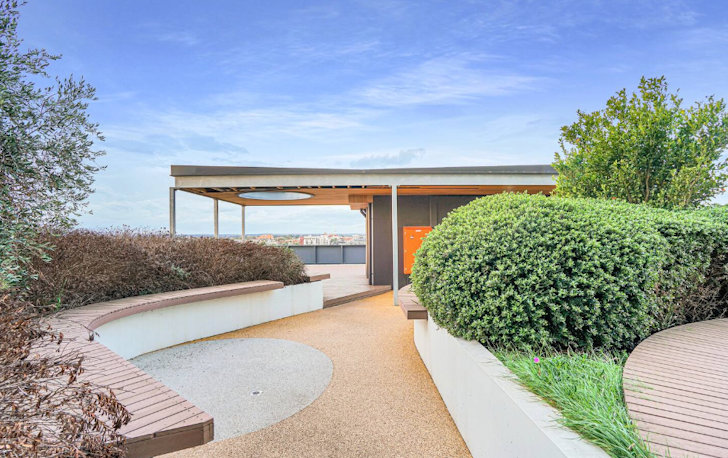 A tan-coloured stone leads up to a Airbnb Melbourne with a flat roof.