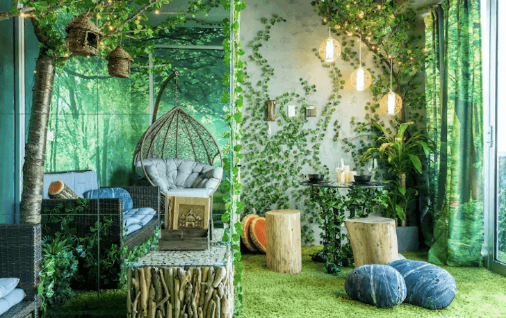 At this Airbnb Melbourne, the lounge room wall are covered in fake vines and carpet is fake grass to mimic that of a forest.