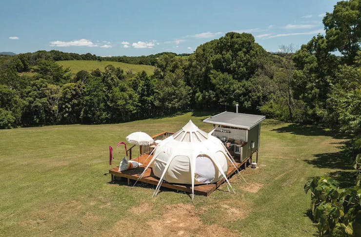 A glamping tent set up in a grassy field near Byron Bay