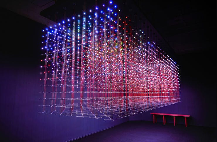 A luminous artwork featuring laser-like lights in a grid pattern at White Rabbit Gallery in Syd. 