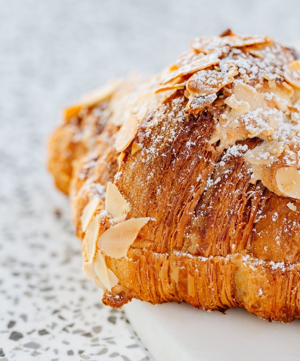 a close-up of a flakey almond croissant