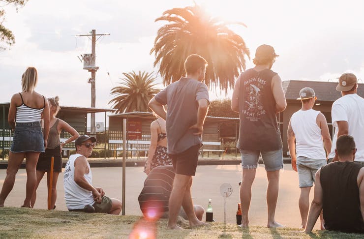 Friends stand around the bowling green at Clovelly Bowling Club in Sydney. 