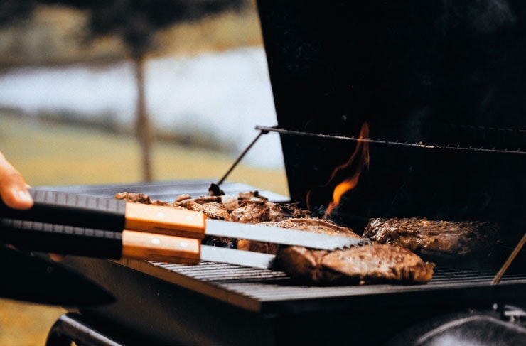Meats on a BBQ in a park