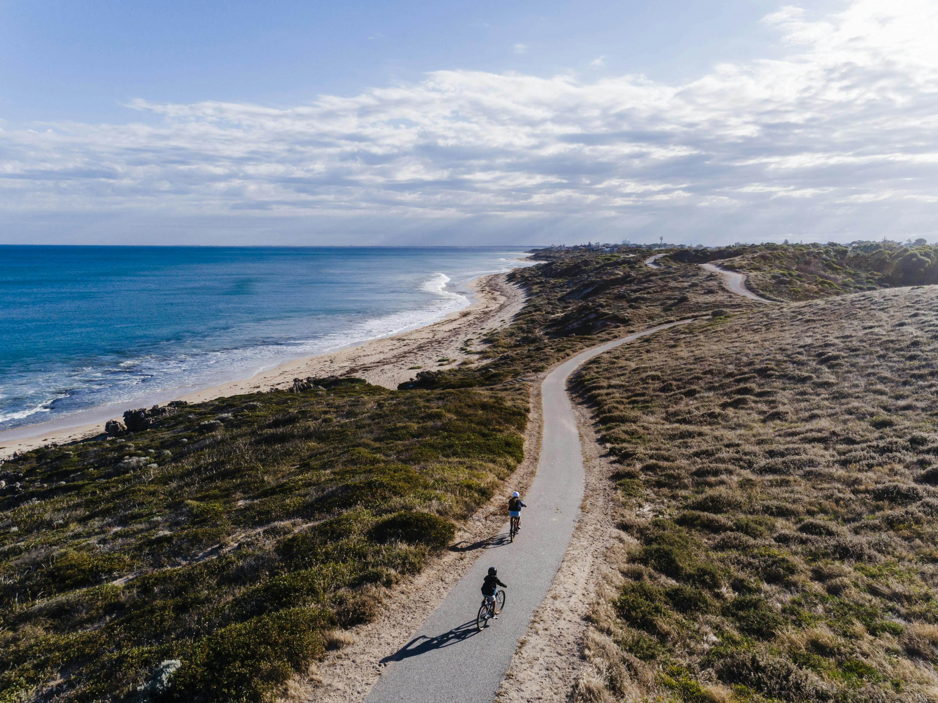two bike riders on a coastal cycle trail in Perth