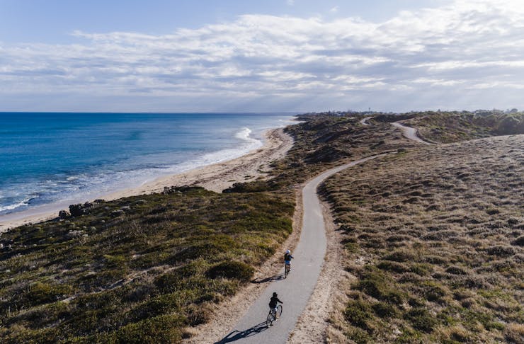 two bike riders on a coastal cycle trail in Perth