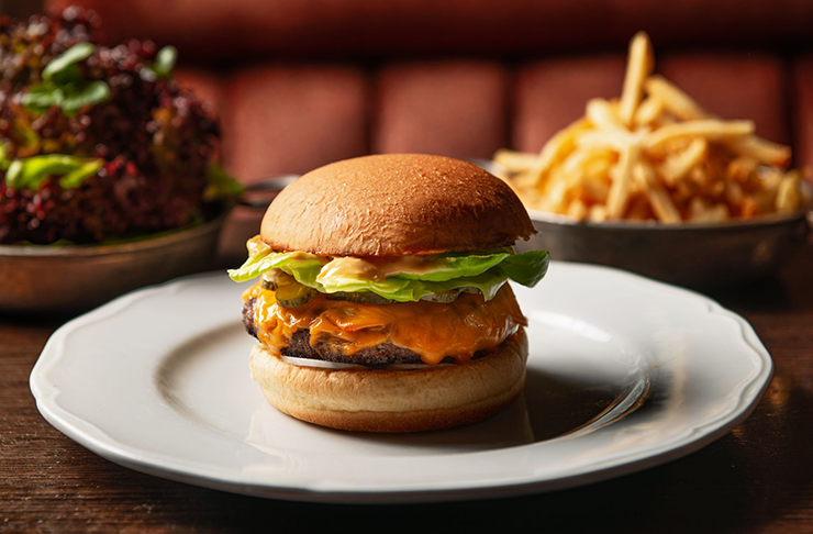 A fancy burger on a white plate at Gimlet, which is considered one of the best burgers in Melbourne as of 2024