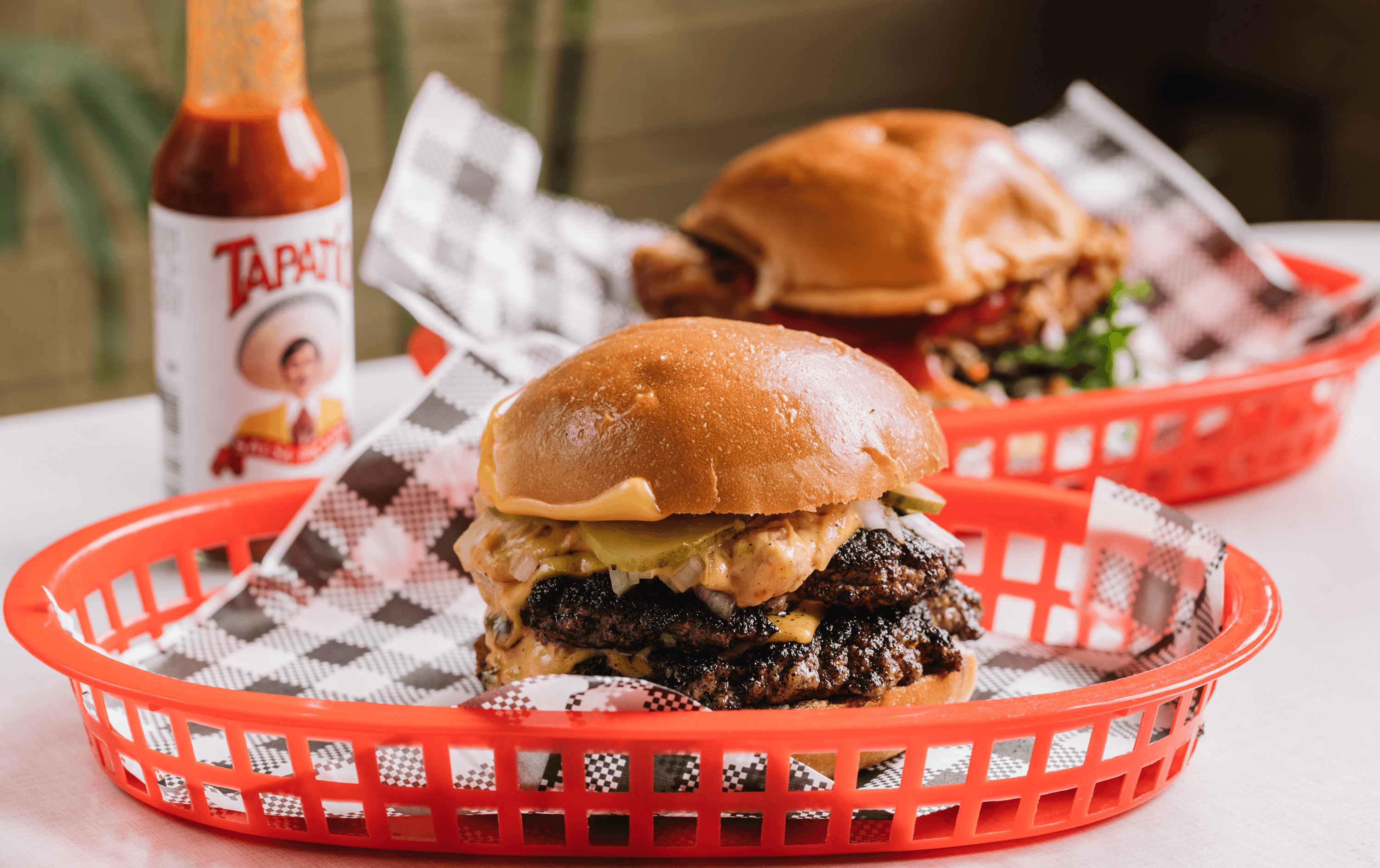 A tall burger in a red tray from Juanita Peaches, one of the best burgers in Melbourne.