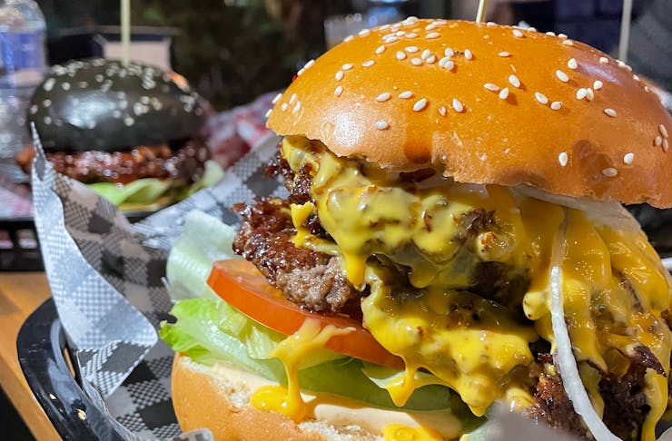 a juicy burger with stacks of beef patties topped with melted cheese