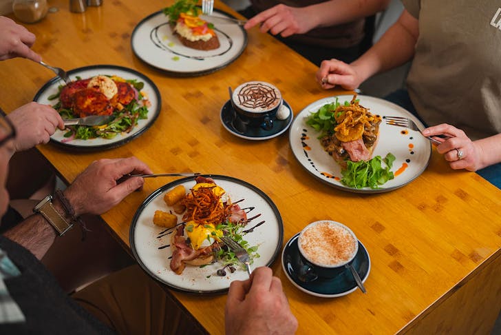 People sit down for a delicious feed at Little Rogue Eatery, one of the best cafes in New Plymouth.
