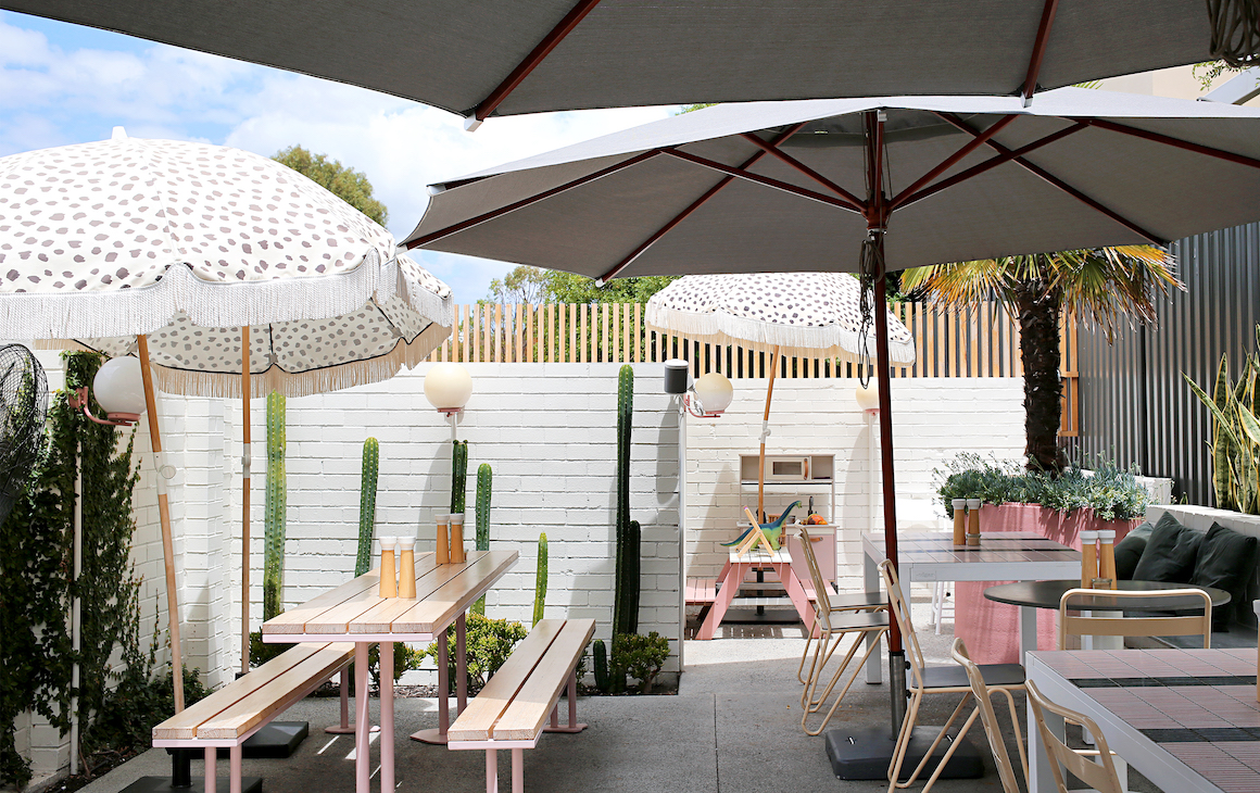 a cafe courtyard with pink furnishings