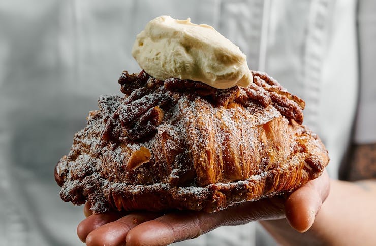 A a Pecan Pie twice baked croissant served with bourbon whipped cream from Lune Croissanterie. 
