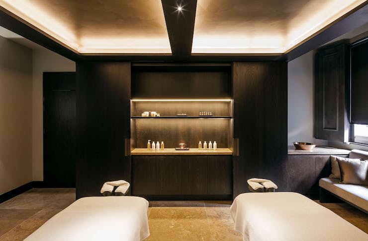 inside a room at one of Perth's best day spas, with minimal decor, mood lighting and two massage beds