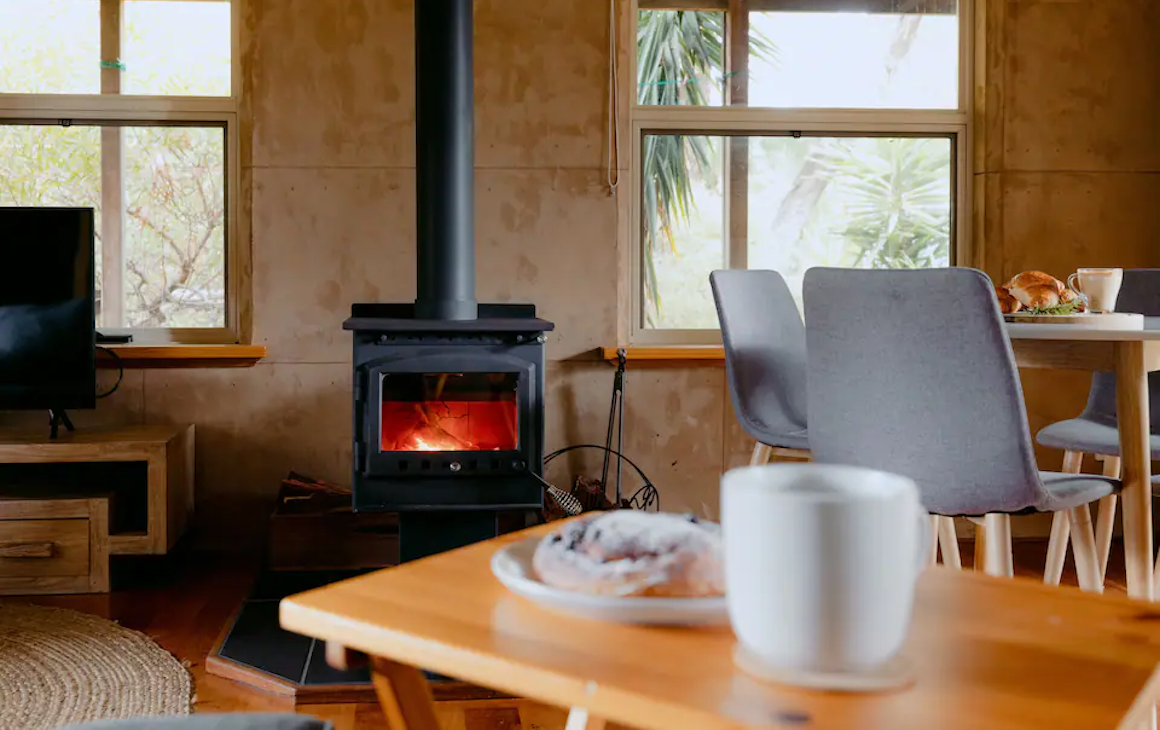 Interior of a cosy cottage with a roaring fire in the fireplace