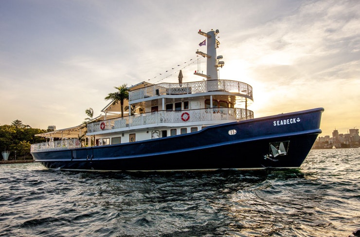 A large blue party boat on Sydney Harbour